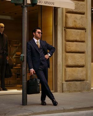 Navy Pinstripe Three-Piece Suit with Yellow Geometric Tie