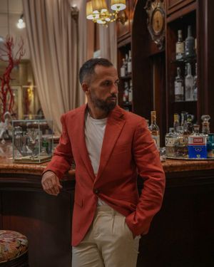 Rust-Colored Blazer with Beige Trousers